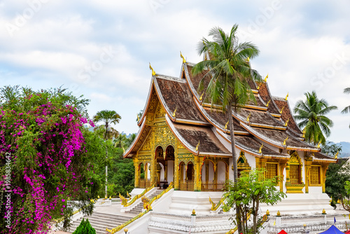 Beautiful historic Wat Xieng Thong temple in Luang Prabang, Laos. Iconic Buddhist architecture and UNESCO heritage landmark surrounded by tropical gardens.