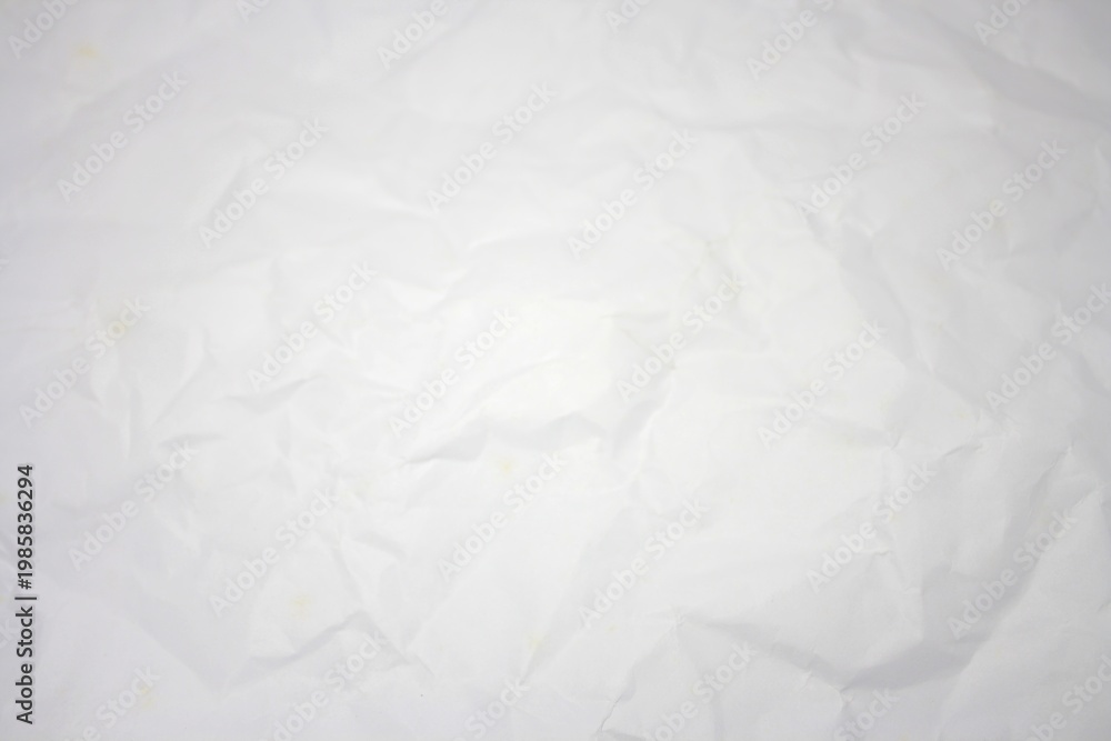 Fototapeta premium Top view of wrinkled white paper surface with copy space