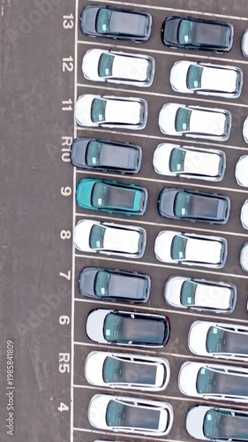 Aerial top view of parked cars in vehicle storage lot