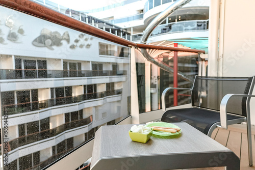 Cruise ship balcony with simple breakfast and modern deck architecture soft daylight and relaxed travel atmosphere at sea