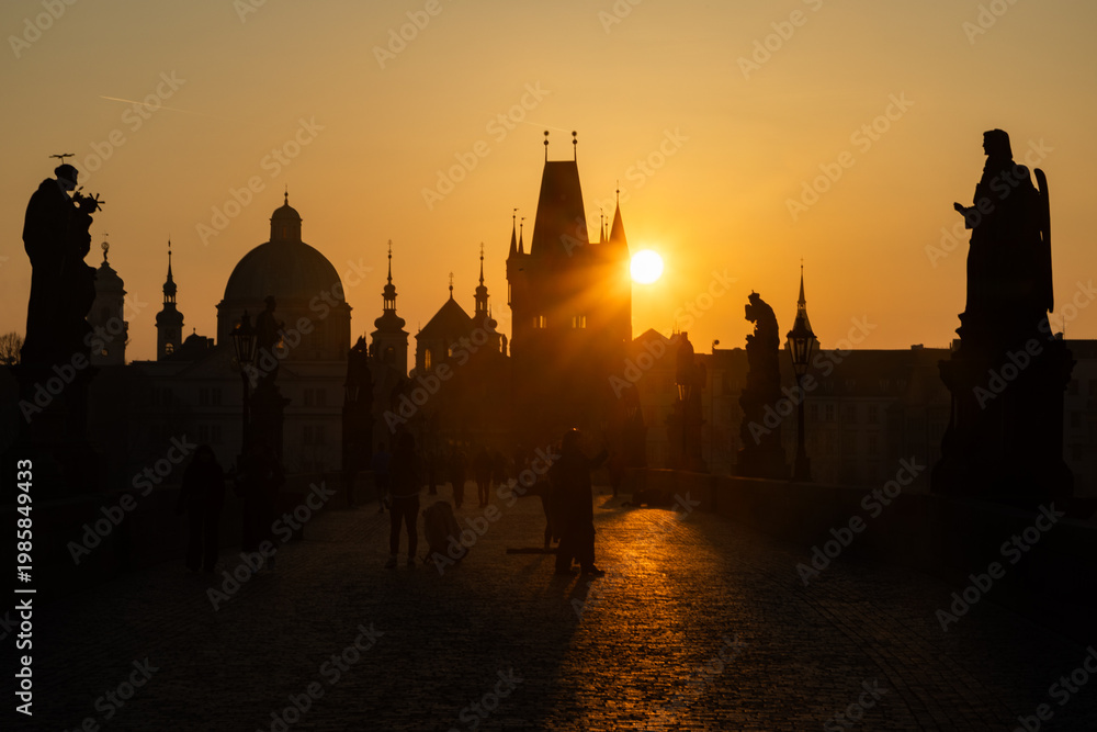 Obraz premium scenic view of Prague Castle and Charles Bridge glowing in golden light over the Vltava River