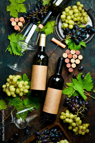 Konstfotografi Composition of wine bottles, glasses, grapes and grape leaves on a stone table