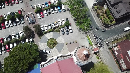 Parking lot space is allotted in front of the ancient colonial church building, situated in the heart of a small city. Drone aerial