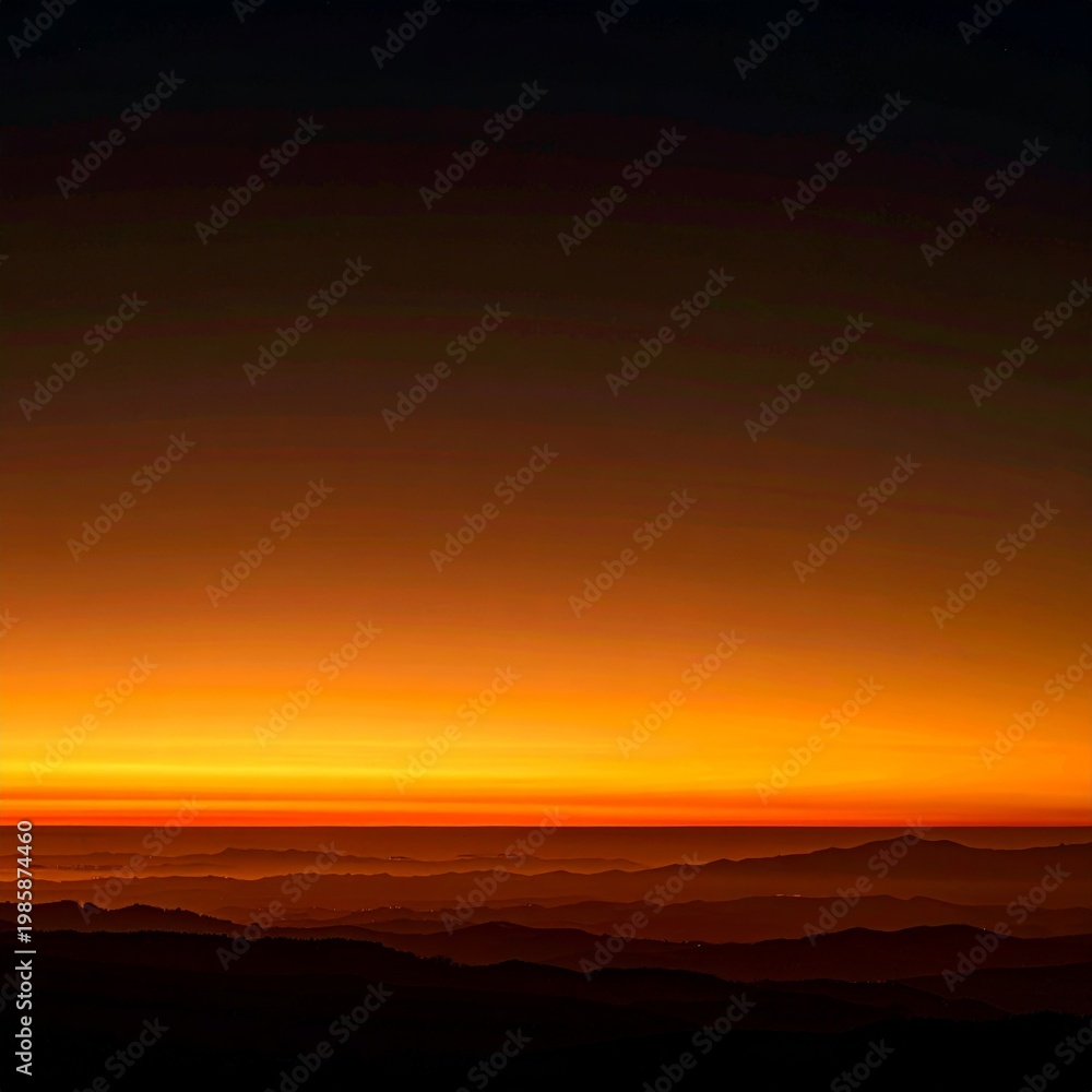 Obraz premium Golden Hour Sunrise Over Mountain Ranges with Bright Orange Sky