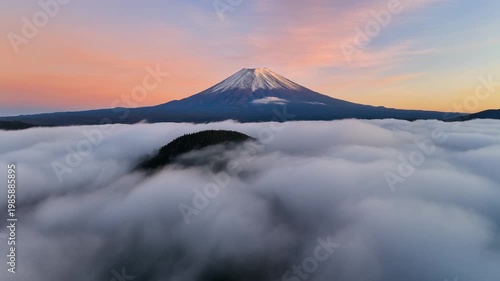 Cinematic FPV drone rising slowly above moving clouds to reveal Mount Fuji