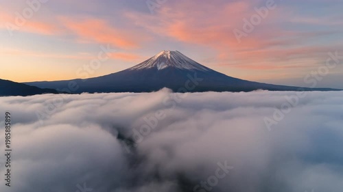 Cinematic FPV drone rising slowly above moving clouds to reveal Mount Fuji
