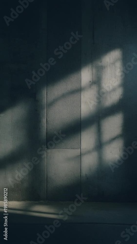 cinematic shot of light and shadow patterns moving slowly across textured concrete wall