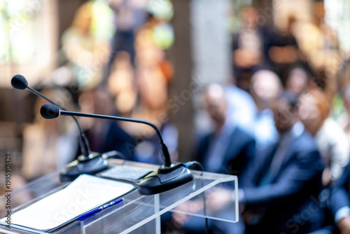Obraz na plátne Microphones in focus at business conference, corporate presentation, workshop, coaching training, news conference, company meeting, public or political event