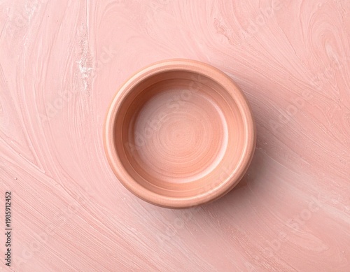 Empty Round Pink Ceramic Bowl Centered on a Textured Pink Background