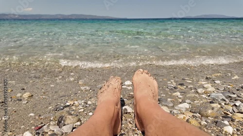 Man sunbathing on a rocky sea ocean beach.