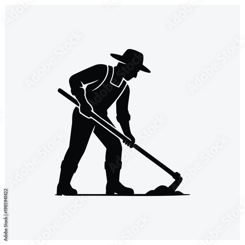 Silhouette of a gardener shoveling soil or working in the garden