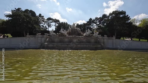 Neptune Fountain at Schonbrunn Palace garden with sculptures and water. Vienna, Austria.