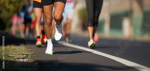Marathon running race, people feet on city road, runners run urban marathon in the the city