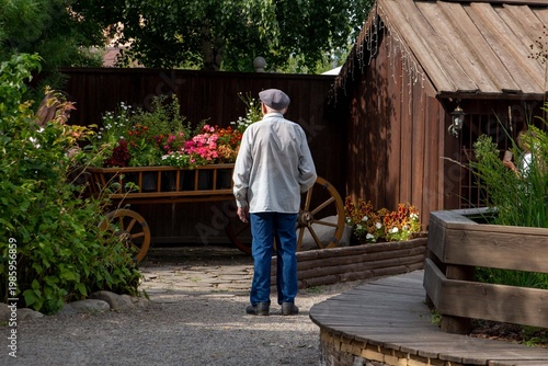 A visitor admires a flower arrangement in a landscape park. Landscape design.