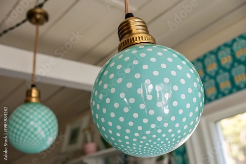 Two Decorative Teal Polka Dot Pendant Light Bulbs Hanging Indoors turquoise