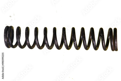 A tightly coiled metal spring is dramatically isolated against a solid black background high-quality professional