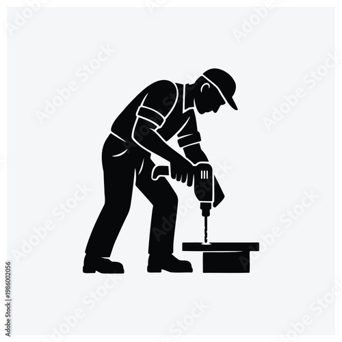 Silhouette illustration of a carpenter using a drill on a piece of wood.