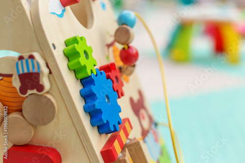 Close up of colorful wooden gears on educational toy