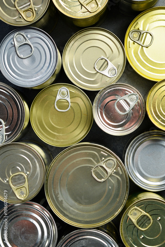 Aluminum cans with canned goods. A large set of canned goods in cans. On a gray background.