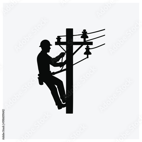 Silhouette of an electrician working on power lines from a utility pole.