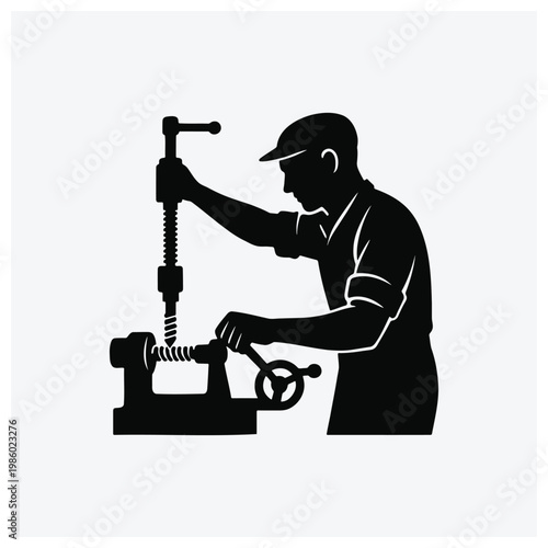Silhouette of a machine shop worker operating a lathe machine for metalworking.