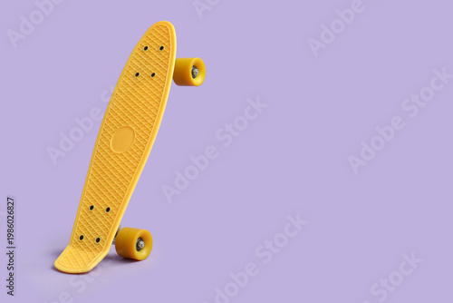 Yellow skateboard on lilac ...