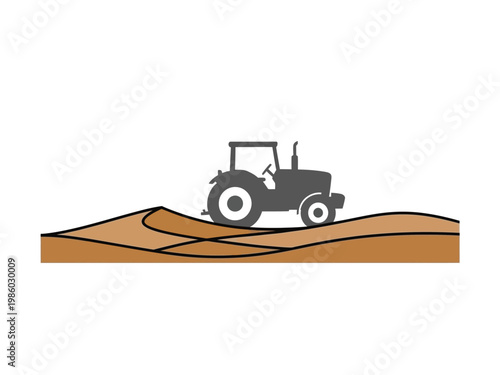 Silhouette of a tractor working on a farm field.