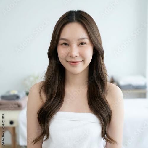 Free Download A young woman smiles warmly in a serene spa setting. - GFXLoad