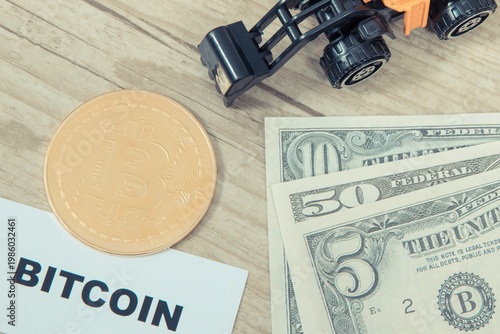 Bitcoin coin, miniature excavator and dollars. Cryptocurrency. International network payment. Finance concept