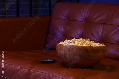 Tasty popcorn with TV remot...