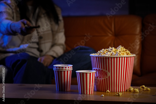 Tasty popcorn with cups on ...