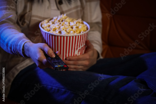 Woman with tasty popcorn wa...