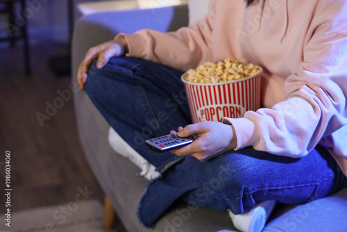 Woman with tasty popcorn wa...