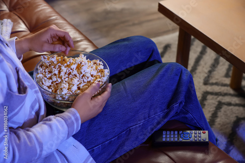 Woman with tasty popcorn wa...