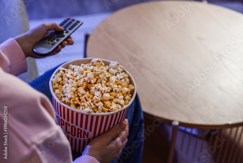 Woman with tasty popcorn wa...