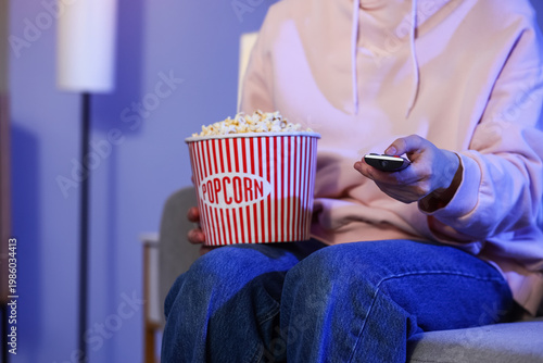 Woman with tasty popcorn wa...