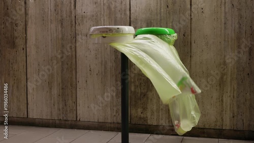 Trash bags moving in subway airflow in Rome metro with underground platform atmosphere and passing train wind