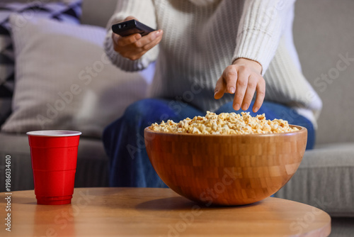 Woman with tasty popcorn wa...