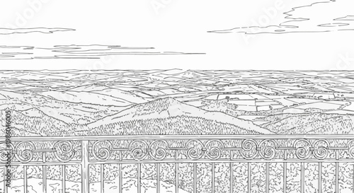 Ornate railing overlooks rolling hills, fields, and distant mountains under clouds