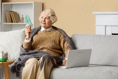 Senior woman with nebulizer...