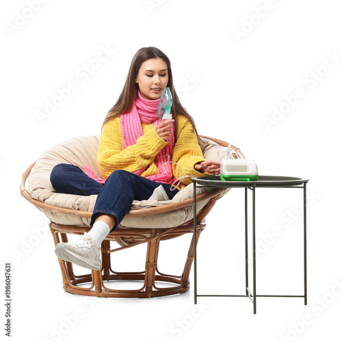 Young woman using nebulizer...