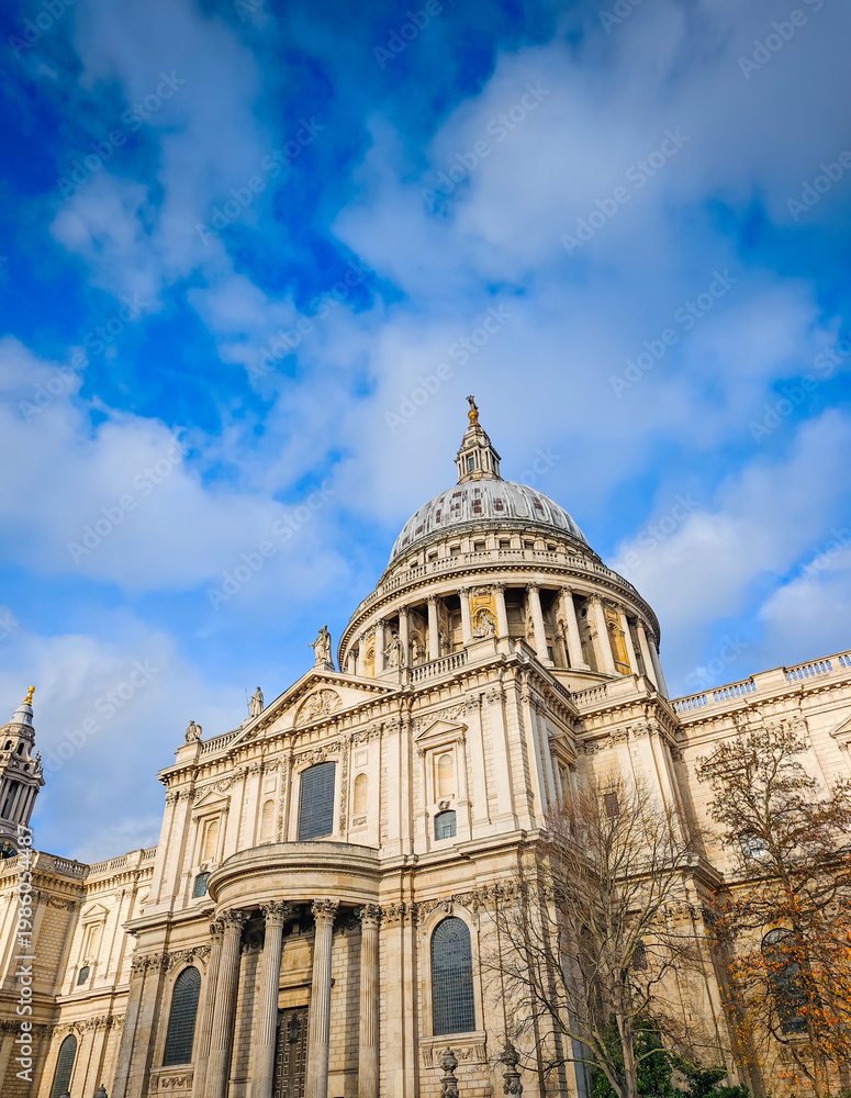 Fototapeta premium St Pauls Cathedral in London on a sunny day, iconic historic landmark with blue sky, famous British architecture and travel destination scene