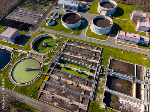 Obraz na plátně Workers manage a wastewater treatment plant in a suburban area during the day wh