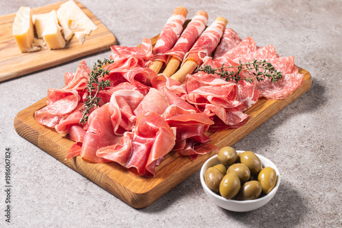 Charcuterie board. Antipasti appetizers of meat platter with salami, prosciutto crudo or jamon and olives.