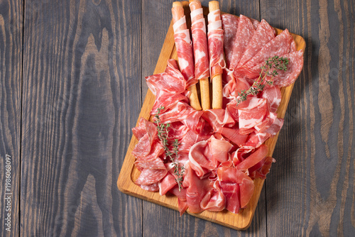 Charcuterie board. Antipasti appetizers of meat platter with salami, prosciutto crudo or jamon and olives.