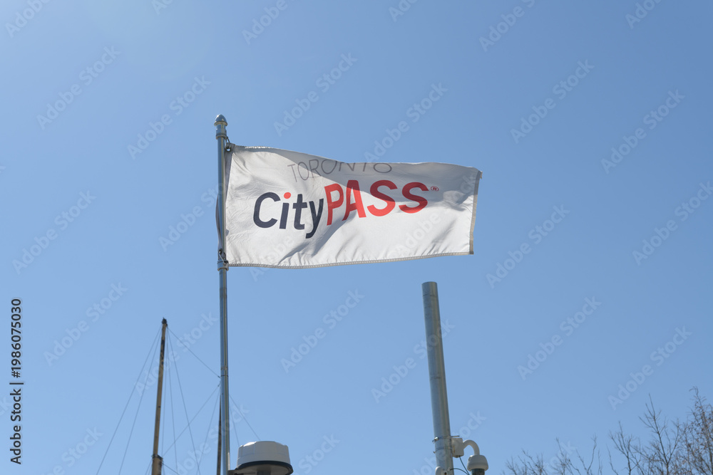 Fototapeta premium Toronto CityPASS flag (popular attractions) on a blue sky