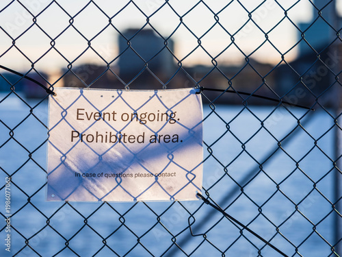 Event ongoing in prohibited area of Gothenburg Sweden with sign on fence