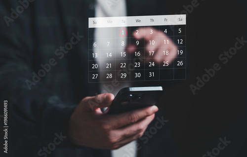 Person using smartphone with digital calendar interface, selecting a date for scheduling, planning, and time management in a modern mobile lifestyle and productivity concept.