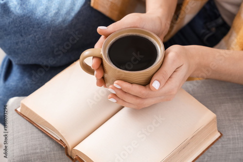 Young woman holding cup of ...