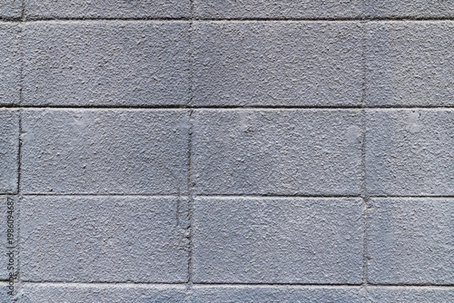 Gray concrete block wall background with rough texture.